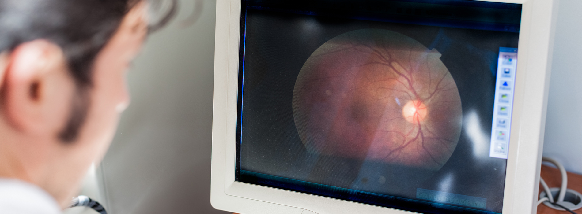 The image shows a person viewing an ultrasound screen with a medical image displayed on it, presumably for diagnostic purposes.